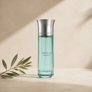 Hero Image: Assaf Arrogate Comete Eau de Parfum for Men 200ml on a warm limestone surface with a delicate olive branch and soft natural daylight.