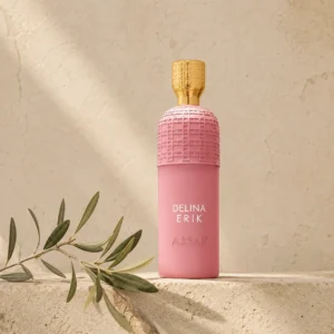 Assaf Delina Erik Eau de Parfum for Women bottle on a warm limestone background with a subtle olive branch and soft natural daylight.