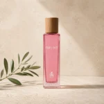 Assaf Feeling Eau de Parfum for Women bottle with a natural wood cap on a warm limestone background with a subtle olive branch.