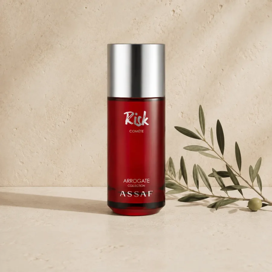 Assaf Risk Comete Eau de Parfum unisex fragrance bottle with silver cap on a warm neutral limestone background with a subtle olive branch.