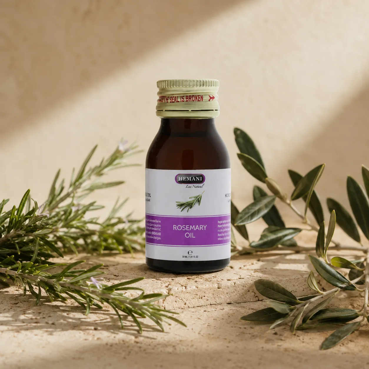 1-hemani-rosemary-oil-30ml-hero Hemani Rosemary Oil 30ml bottle with original packaging displayed as the focal point alongside fresh rosemary sprigs and subtle olive branches in a refined DARLEVANT botanical hero setting with soft natural daylight.