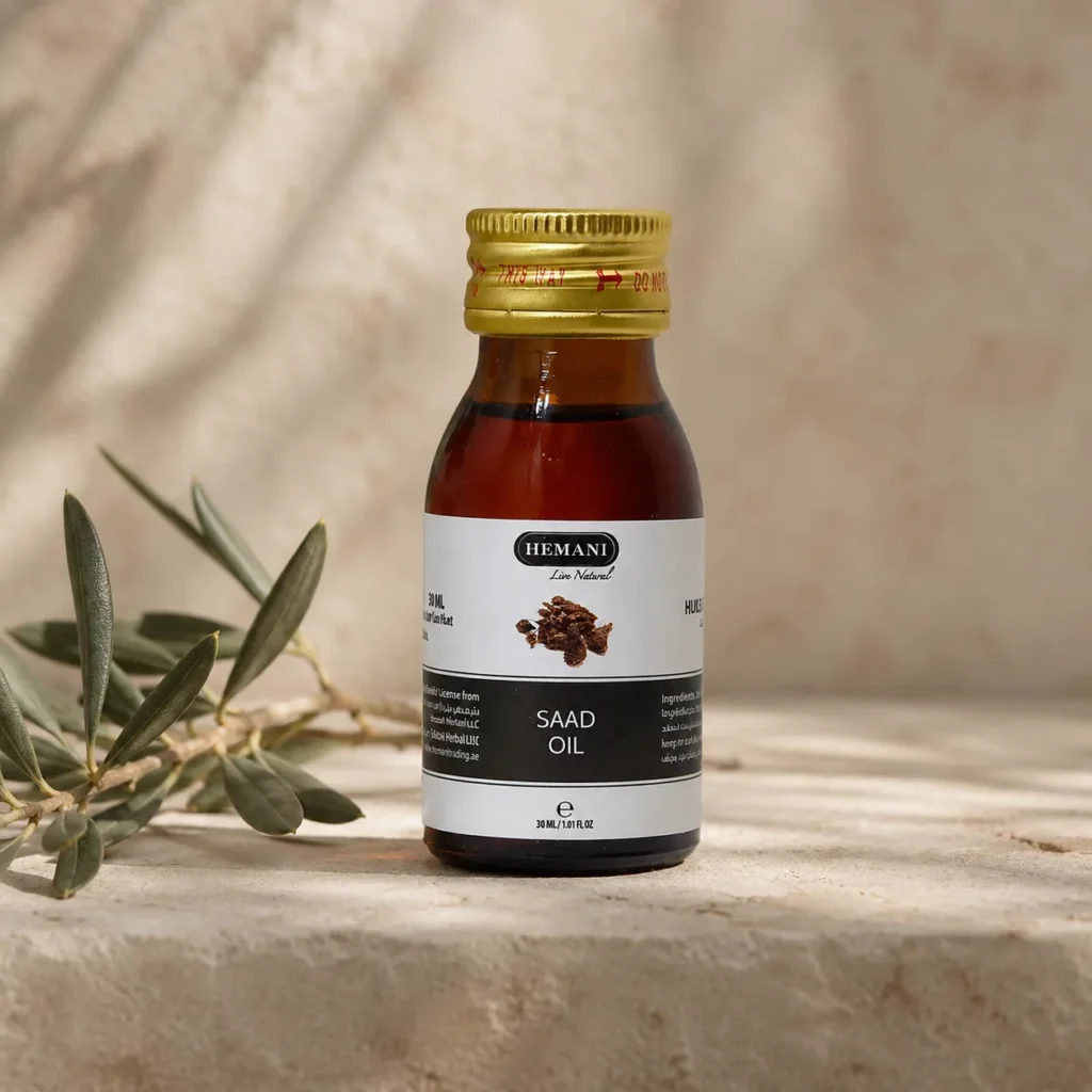 Hemani Saad Oil 30ml bottle with original packaging displayed as the focal point in a refined DARLEVANT hero scene with a subtle olive branch, warm neutral background, and soft natural daylight.
