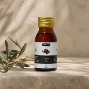 Hemani Saad Oil 30ml bottle with original packaging displayed as the focal point in a refined DARLEVANT hero scene with a subtle olive branch, warm neutral background, and soft natural daylight.