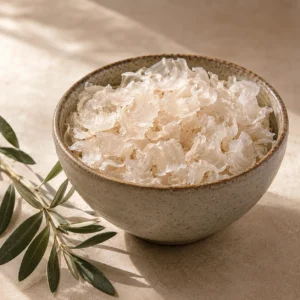 Handcrafted ceramic bowl filled with authentic Kathira flakes displayed in a minimal DARLEVANT hero scene with olive branch and warm natural lighting.