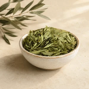 Premium Senna Leaves Herbal Infusion 250g in an artisanal white ceramic bowl with an olive branch on a warm neutral background, showcasing whole senna leaves with natural texture and traditional botanical character.