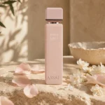 ASSAF Pink Lady Eau de Parfum bottle with orange blossom flowers on a warm neutral background in soft natural daylight