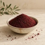 Authentic Jordanian sumac from Anjara presented in a handcrafted ceramic bowl on natural limestone