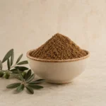Levantine Seven Spice Blend in a handcrafted ceramic bowl with olive branch accents and warm natural daylight.