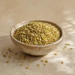 Traditional coarse freekeh presented in a handcrafted ceramic bowl on natural limestone in a refined pantry setting