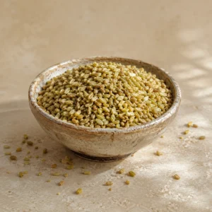 Traditional coarse freekeh presented in a handcrafted ceramic bowl on natural limestone in a refined pantry setting