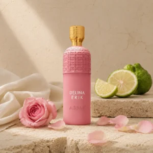 Assaf Delina Erik Eau de Parfum surrounded by fresh bergamot slices and delicate pink rose petals on warm limestone surfaces.