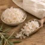 Traditional pantry presentation of Kathira flakes in a ceramic dish and wooden scoop with linen fabric and natural olive branch accents.