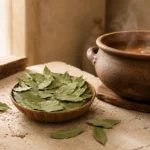 Dried bay leaves beside a traditional clay cooking pot in an authentic Levant-inspired kitchen scene