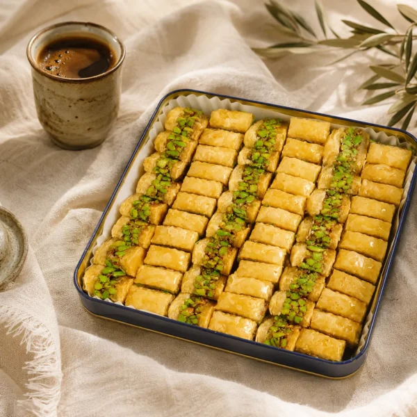 Traditional pistachio baklava fingers served with Arabic coffee in a warm Levantine coffee ritual setting with natural daylight and handcrafted ceramics.