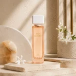 Signature Style Image: Assaf Miss Sakura Eau de Parfum for Women displayed on layered travertine platforms with alabaster accents and refined architectural details.