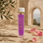 ASSAF Gris Erik Eau de Parfum bottle with rose petals and olive branch shadows on natural stone against a softly blurred Levantine limestone arch background