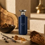 Assaf King Enable Eau de Parfum for Men 150ml with amber resin, aromatic wood chips, tobacco leaf, and subtle olive wood accents in a contemporary Middle Eastern setting.