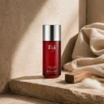 Assaf Risk Comete Eau de Parfum bottle with sandalwood accents and soft natural textures in a modern Arabian-inspired lifestyle scene.