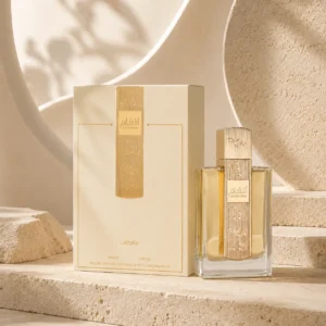 Lattafa Angham Eau de Parfum 100ml bottle and original box in a contemporary editorial setting with curved plaster forms and layered neutral textures.