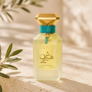 Hersh 2 by Al Ezz Oud Eau de Parfum highlighting its golden cap and turquoise cord in an elegant Mediterranean-inspired setting
